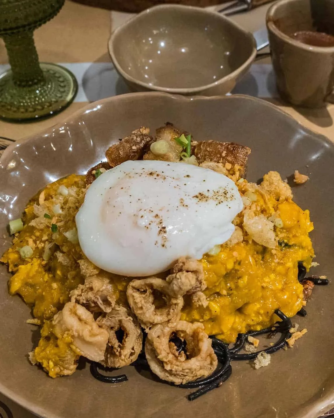 Cacao Smoked Black Palabok: black noodles with seafood and a poached egg