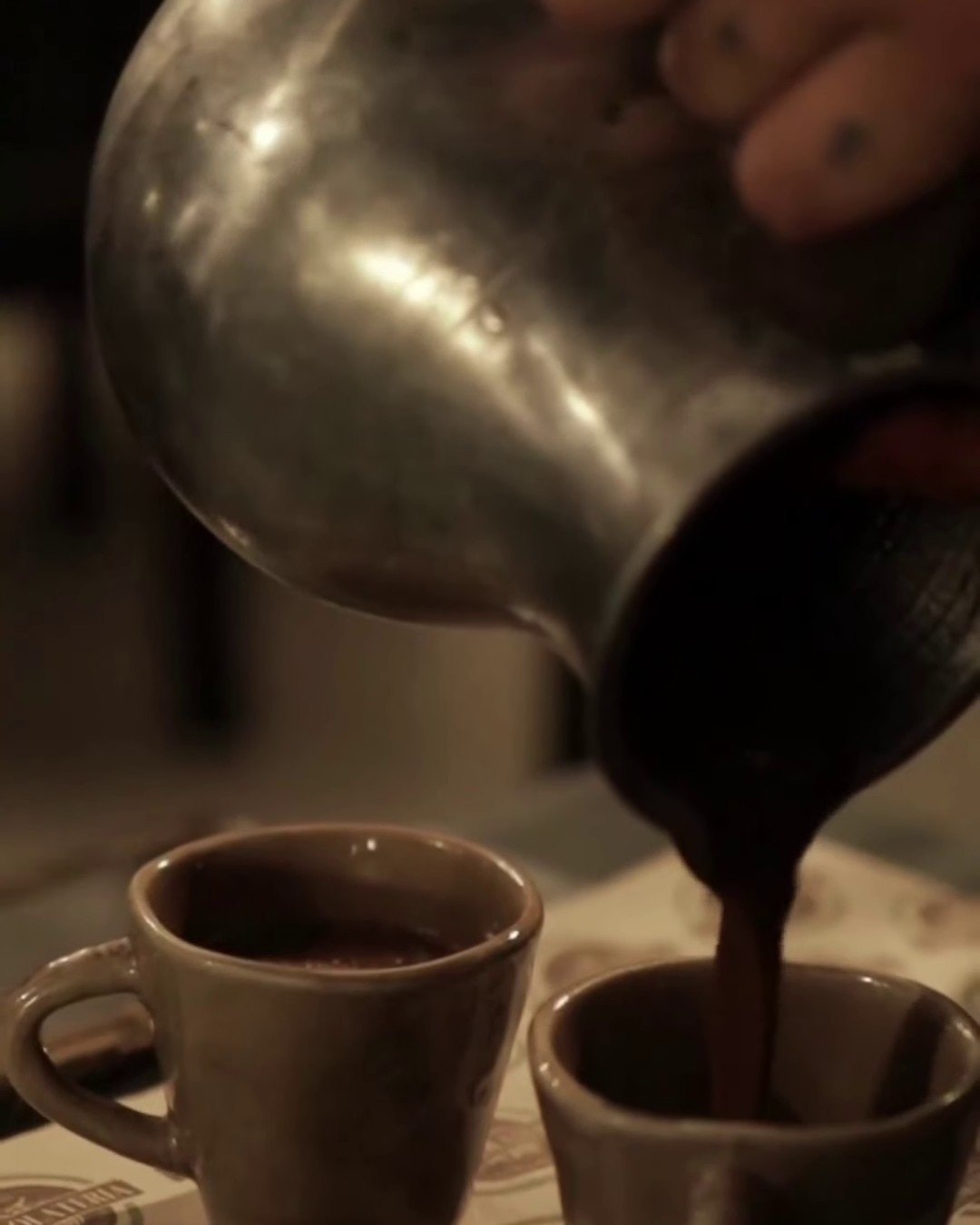 Thick tsokolate poured from the silver pot